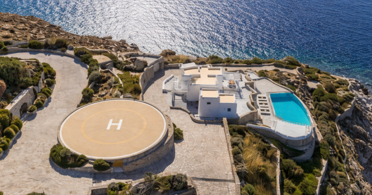 Aerial view of Mykonos coastline with luxury villas and turquoise Aegean waters, symbolizing high-end Mediterranean travel.